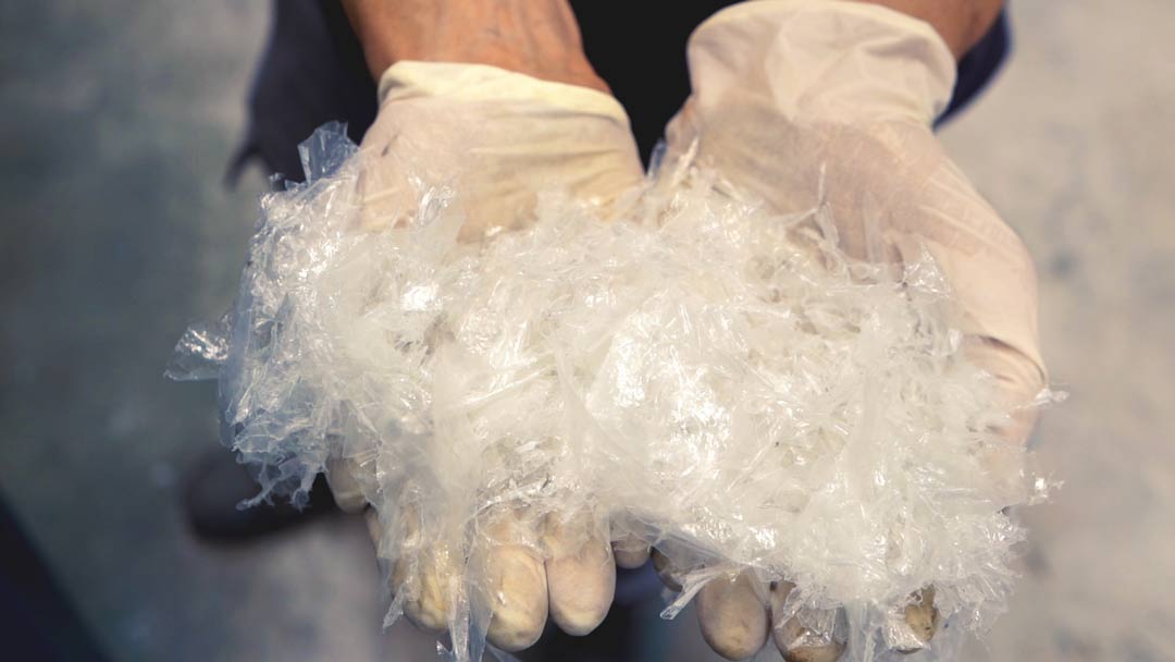 hands in latex gloves holding plastics for recycling